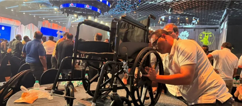 A group of corporate employees working together to assemble a wheelchair as part of a CSR team-building event.