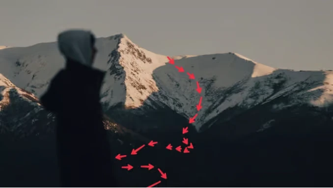A person looking at a snow-covered mountain with a red arrow path marking a winding climbing route, symbolizing strategic decision-making and business roadmaps