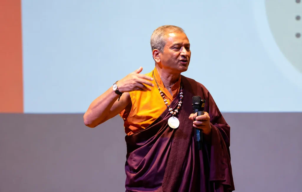 Dr. Saamdu Chetri, expert on Gross National Happiness, presenting at a corporate conference