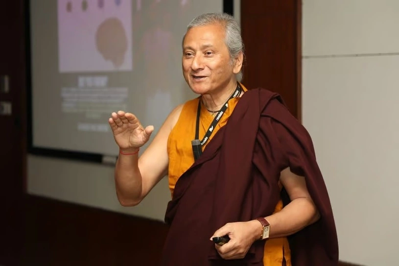Dr. Saamdu Chetri, founder of Bhutan's Gross National Happiness (GNH) Centre, speaking at a corporate event