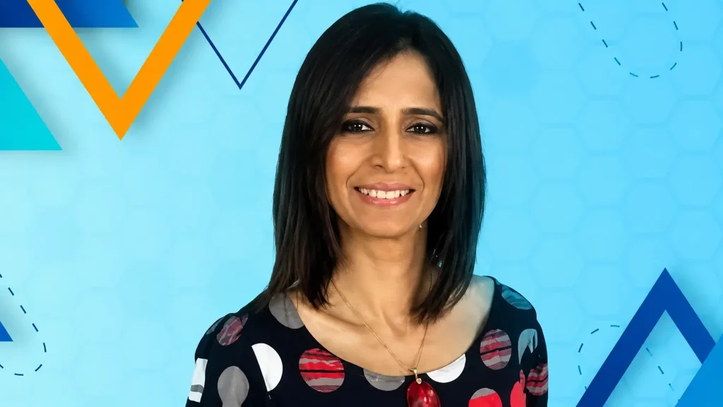 Blog banner featuring corporate speaker Pooja Ruprell with abstract blue and orange geometric graphic elements