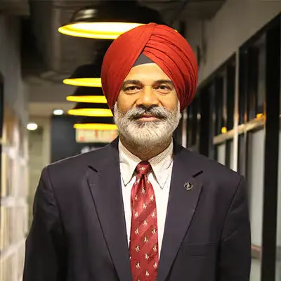 Lt. Gen. Balbir Singh Sandhu, wearing a suit and a red turban, posing for a portrait
