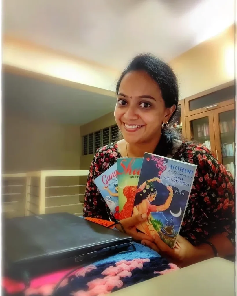 Anuja-Chandramouli-With-Mythology-Books Author Anuja Chandramouli smiling and holding three of her mythological books, including Shakti and Mohini