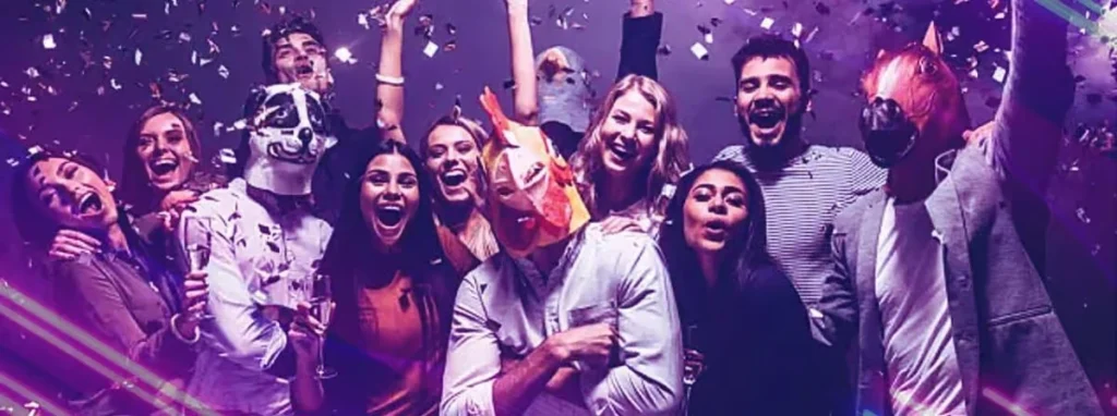 A high-energy corporate party banner showing a diverse group of people celebrating with confetti, some wearing animal masks like a dog, rooster, and horse, set against a vibrant purple and pink light background.