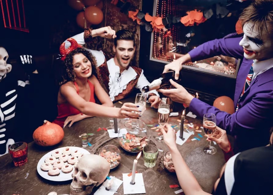 A high-production Halloween event setup featuring an eerie scarecrow with a pumpkin head, glowing jack-o'-lanterns, and atmospheric green and purple lighting.