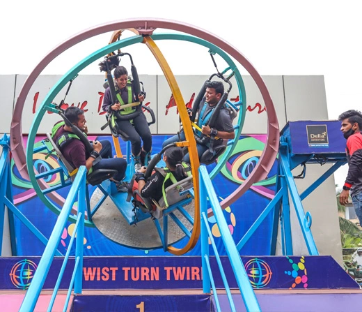 Corporate team experiencing the Human Gyroscope ride at Della Adventure Park Lonavala during an engage4more team building offsite
