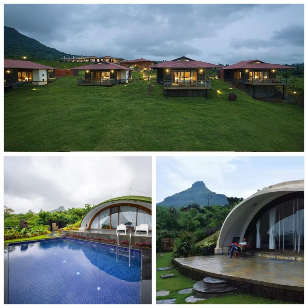 A row of luxury stone-and-wood villas with red-tiled roofs nestled on a lush green hillside at Amanzi Resort, Pawna, under an overcast sky