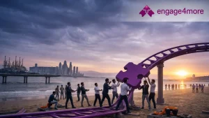 A corporate team collaborating on a purple puzzle-piece structure on a beach at sunset, representing engage4more’s team building expertise in India.