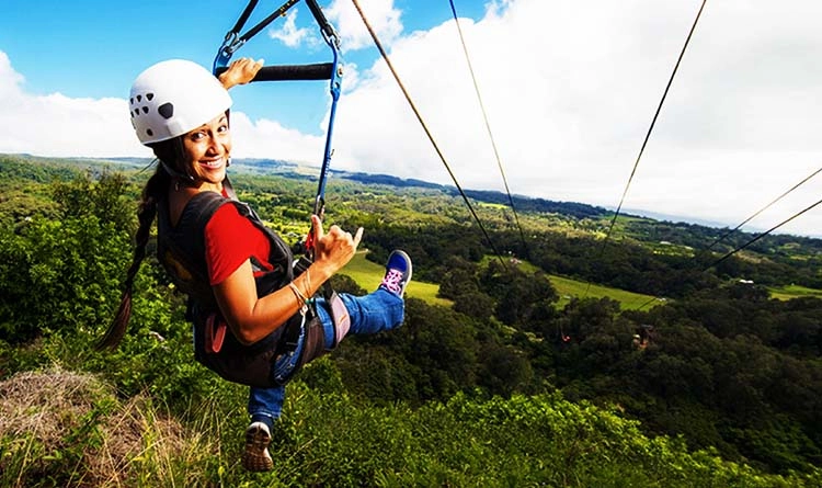 A female corporate professional ziplining at Vishwasgadh Adventure Resort in Malavli, a heritage-adventure hybrid venue near Lohagad Fort