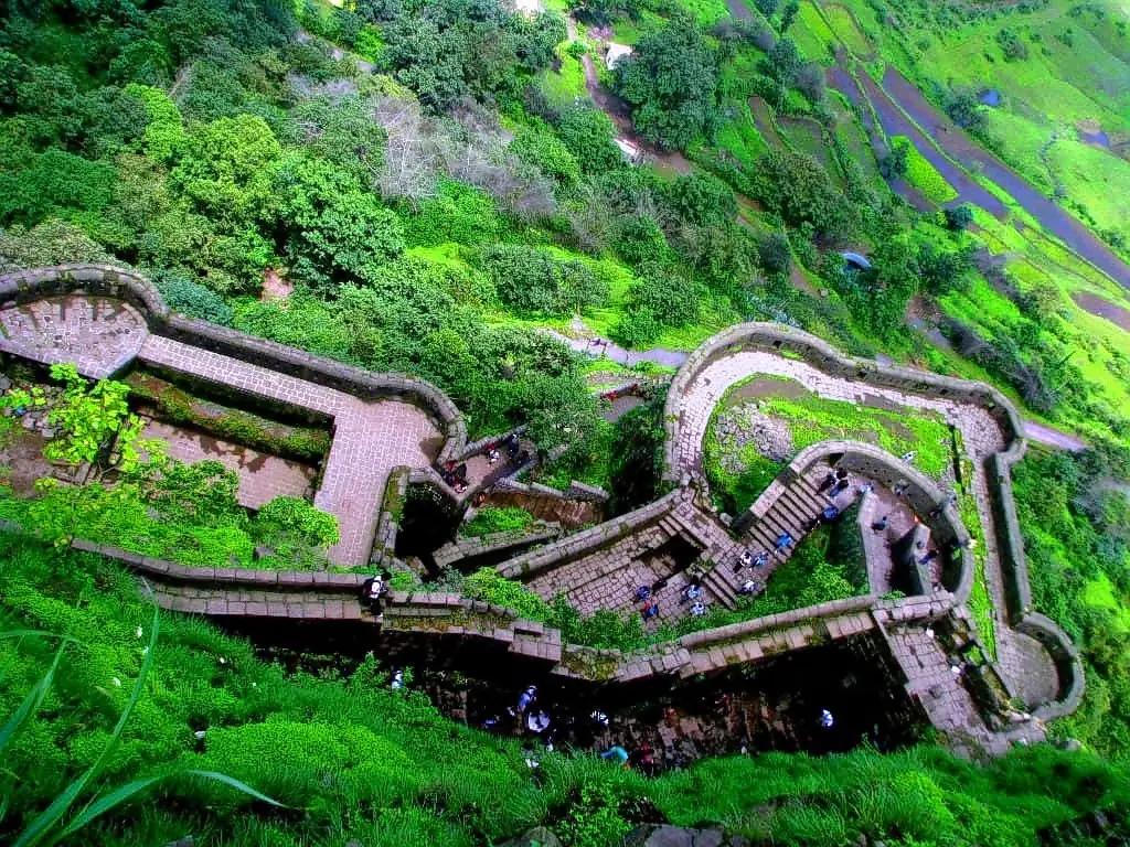 Aerial view of the stone fortifications and steps of Lohagad Fort near Lonavala, a popular destination for corporate trekking and team building.