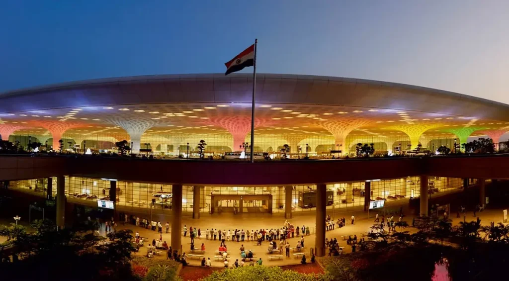 chhatrapati-shivaji-mumbai-airport- The illuminated exterior of Chhatrapati Shivaji Maharaj International Airport (BOM) Terminal 2 at night, a primary arrival point for corporate teams in Mumbai.