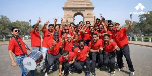 Why engage4more is the Top Team Building Company in Delhi NCR: 5 Premium Business Hotels for 2026 A scenic wide-angle view of the India Gate at sunset, with its grand archway illuminated and the surrounding lush lawns and water features reflecting the golden sky.
