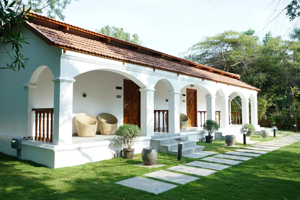 Heritage-style white villas with terracotta roofs at Browntown Resort Moinabad