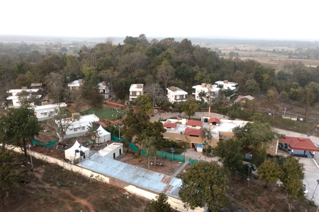 Aerial drone view of Feriado Resorts Tadvai showing cottages nestled in dense forest